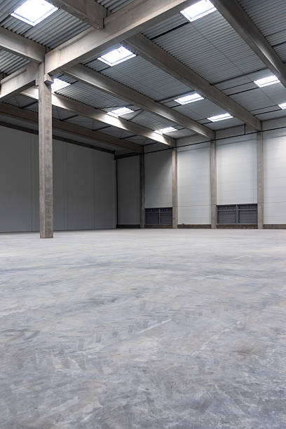 istock The empty interior of a large industrial warehouse. 2236718527