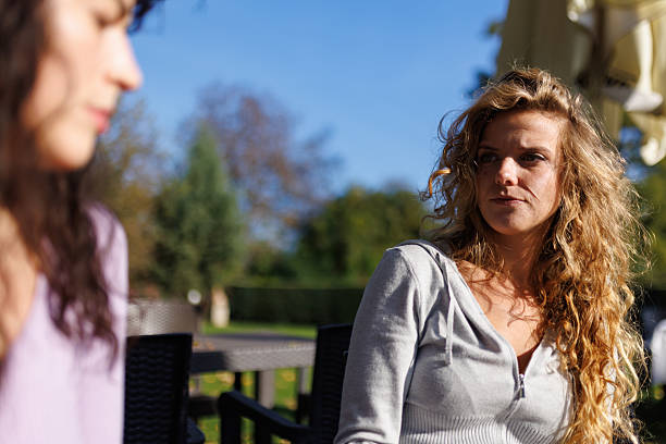 istock Friends enjoying a sunny day outdoors while having an engaging conversation at a cafe 2236719214