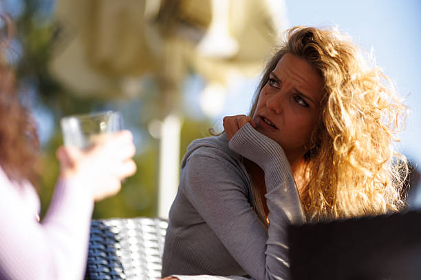 istock Glistening sunlight captures a thoughtful exchange between two friends outdoors during a bright afternoon gathering near a stylish terrace 2236719224