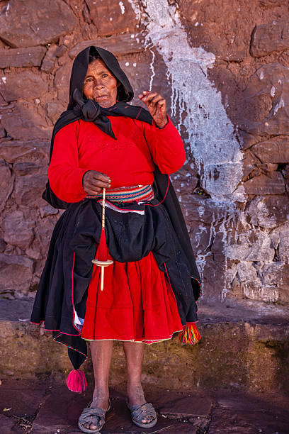 istock Woman spinning a wool by hand on Taquile Island, Peru 2236720639