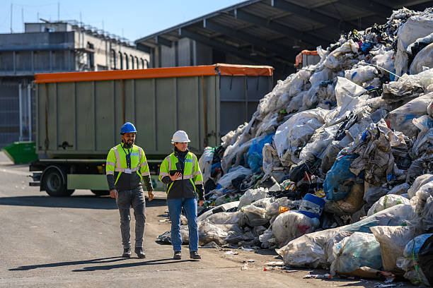 istock Team Inspecting Waste Management Operations at Recycling Center 2236722470
