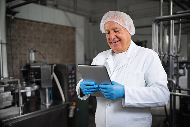 istock Senior Owner Using Tablet in a Dairy Production Facility 2236723412