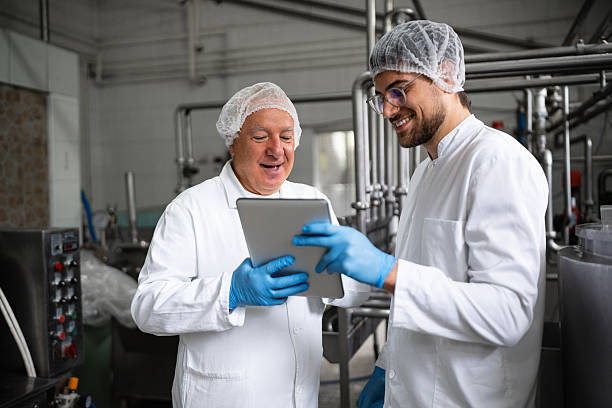 istock Professionals collaborating in a dairy processing plant for production and quality control 2236724090