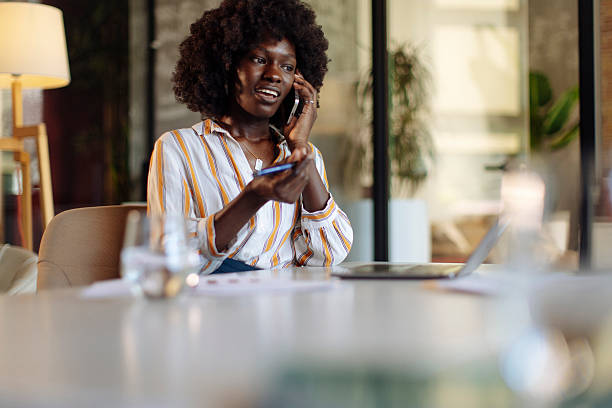 istock Professional Woman in a Modern Office Talking on Smartphone 2236724268