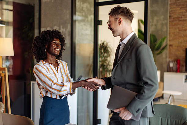 istock Two Professionals Shaking Hands After a Successful Business Meeting in a Modern Office 2236724296