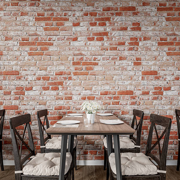 istock Cozy restaurant interior with a rustic exposed brick wall and wooden furniture (tables and chairs), empty brick wall background with copy space 2236724619