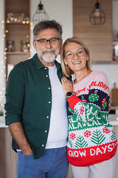 istock Senior couple celebrating christmas wearing ugly sweaters 2236726966