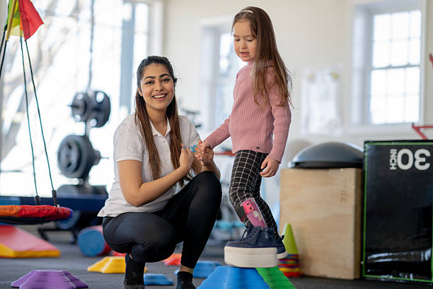 istock Therapist And Young Girl With Limb Difference Engage During Pediatric Physiotherapy Session — Joyful Training 2236728975