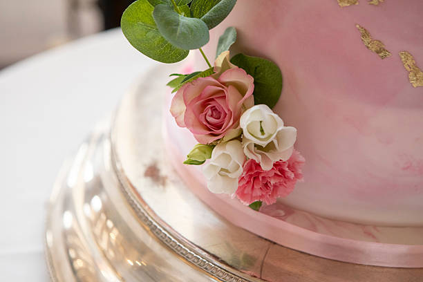 istock Close-up of pink flowers on a wedding cake 2236729189