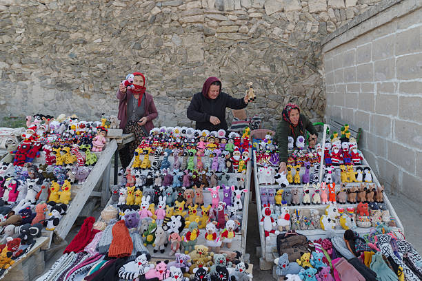 Saratli, Kirkgoz, Turkey - November 14, 2024: Unidentified women selling handmade dolls in front of underground city in Kirkgoz, Saratli in Cappadocia