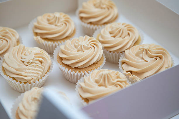 Chopped view of a cupcake on a plate served on a long table.