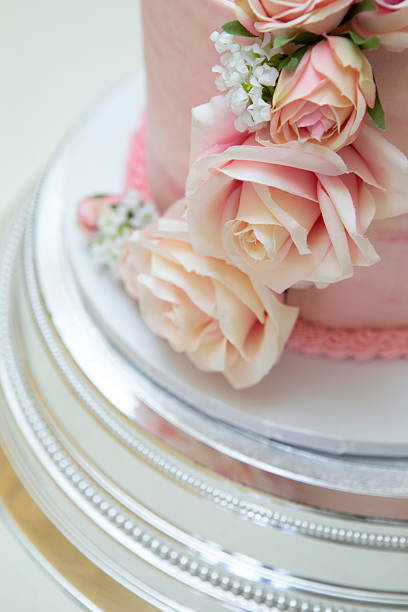 istock Close-up of pink flowers on a wedding cake 2236729449