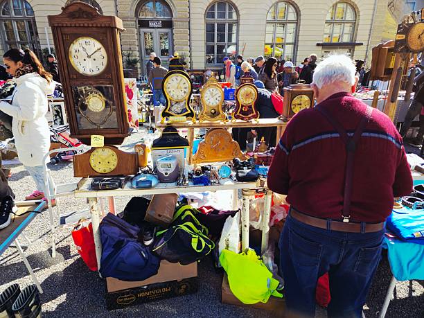 The Flea Market Kanzlei in Zurich is one of two big Second Hand Marked in Town. It is located in the 4th District next to the Helvetia Square. The Market is opened every Saturday. The image show several several people at the market captured during spring season.