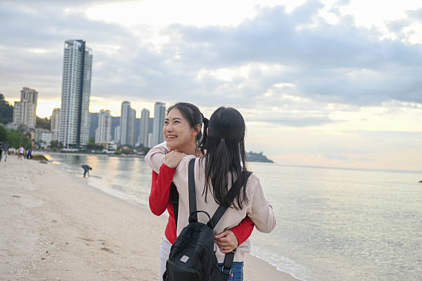 Relaxed and happy, two women enjoy the peaceful sounds of waves and salty air.