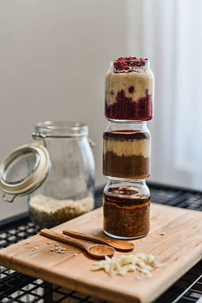 Assorted Flavored Overnight Oats Stacked In Jars One On Top Of Other Neatly