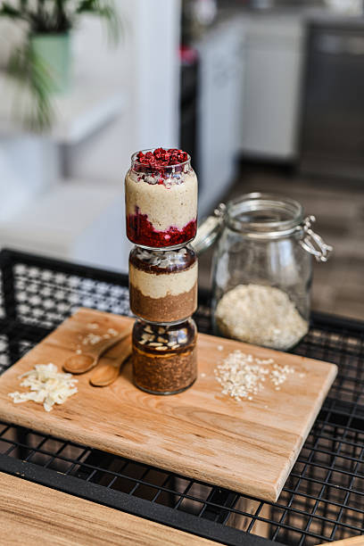 Jars With Different Flavored Overnight Oats Positioned Vertically One Above Other