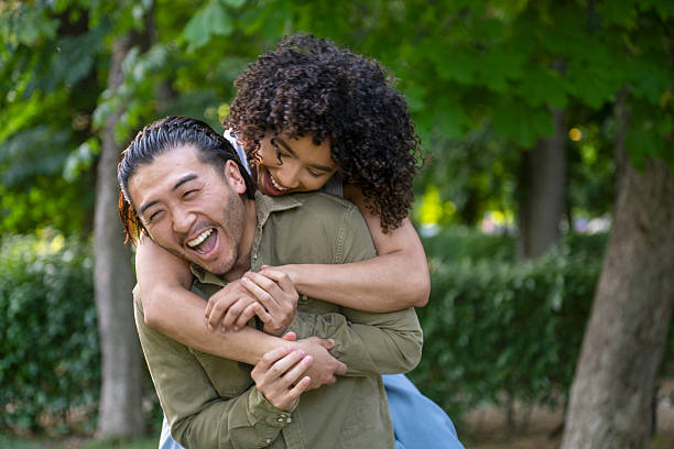 istock Interracial couple having fun piggybacking in the park 2236736832