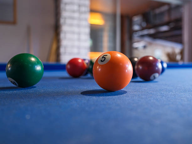 Vibrant billiard balls arranged on a blue felt pool table