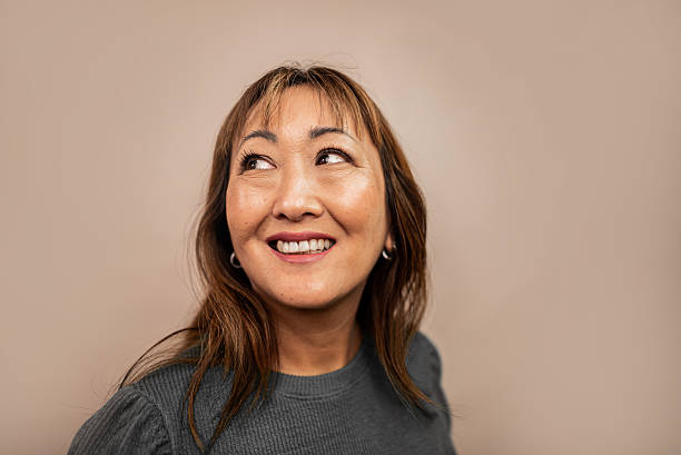 istock Mature woman contemplating looking away in a studio shot 2236738947