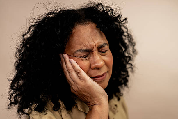 istock Mature woman with a toothache in a studio shot 2236739092