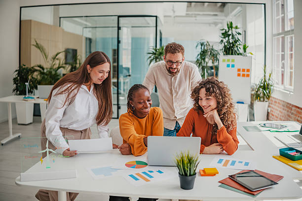 istock Young professionals collaborate in a modern startup office as they work on a project and share ideas 2236739530