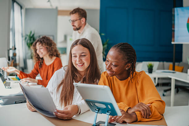 istock Young professionals collaborate in a modern startup office while discussing ideas and planning projects for their business success 2236740010