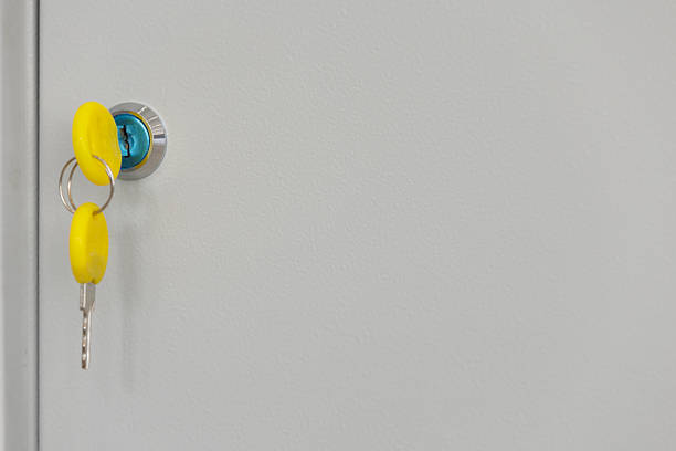Key in lock on plain surface. Minimal interior lock and key close-up with copy space.