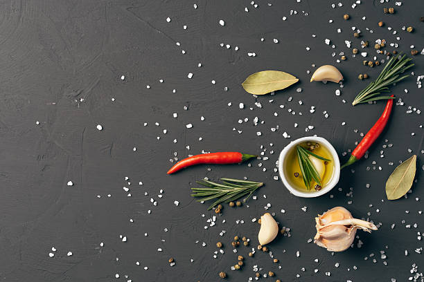 istock Salt and spices scattered on black background 2236740397