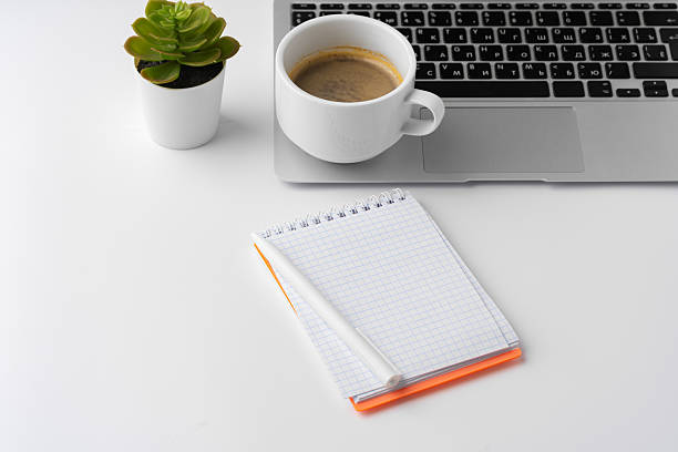istock Office desk with laptop, blank notebook and coffee cup 2236740466