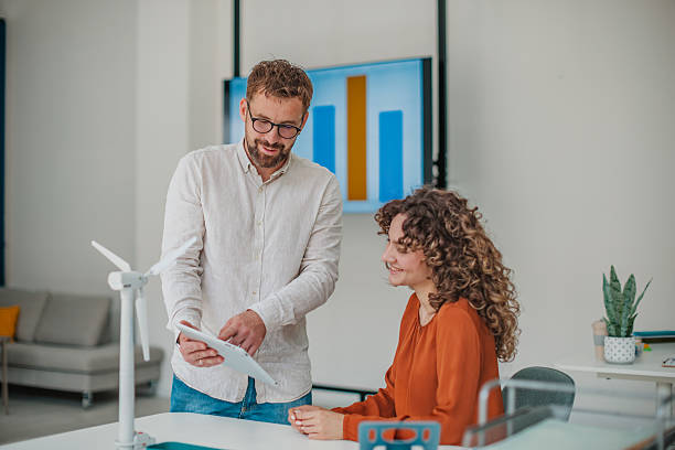 istock Young professionals collaborate joyfully in a modern startup office, exchanging ideas and fostering teamwork for business growth 2236740766