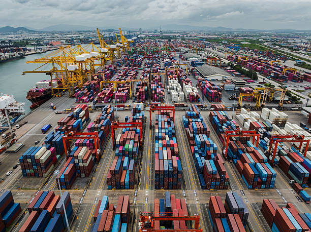istock shipping logistic, commercial port load and unloading cargo from container ship import and export by crane for distributing goods by trailers transported to customers and dealers 2236742772