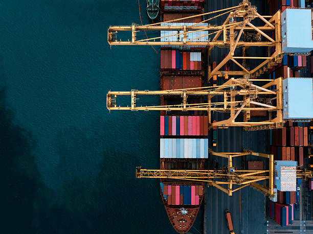 istock commercial port load and unloading cargo from container ship import export by crane for distributing goods by trailers transported to customers and dealers, 2236742780