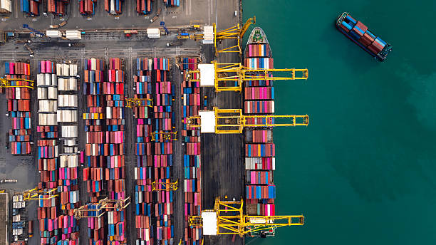 istock commercial port load and unloading cargo from container ship import export by crane for distributing goods by trailers transported to customers and dealers, 2236742844