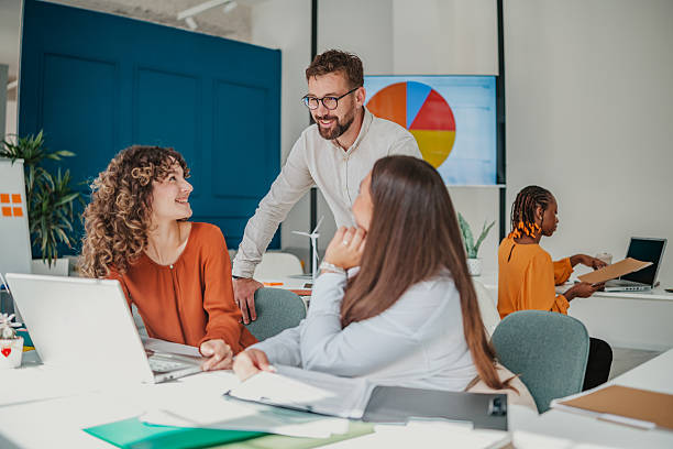istock Young team collaborating in a bright startup office while sharing ideas and planning for future success 2236743086