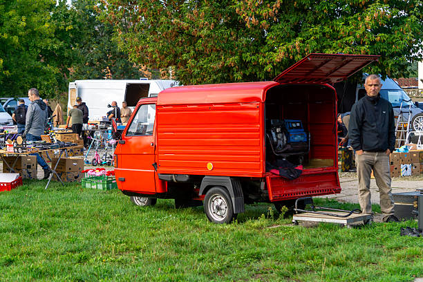 Ostrów Wielkopolski, Greater Poland Voivodeship, Poland - september 13, 2025 At the market stands a small red three-wheeled Piaggio Ape delivery vehicle with open cargo space, used for transporting goods.
