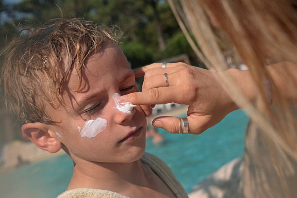 istock Mother applies sunscreen on young boy 2236745595