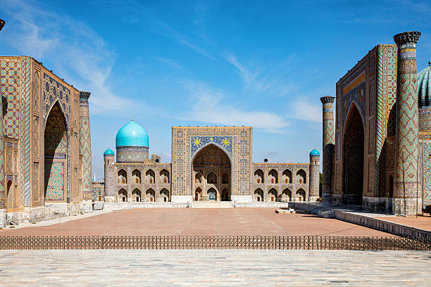 istock Registan Square in Samarkand, Uzbekistan, a historic architectural ensemble featuring three stunning madrasas with intricate mosaic designs, domes, and minarets under a bright blue sky 2236748478