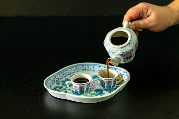 istock A person is pouring coffee into two cups from a teapot 2236748859