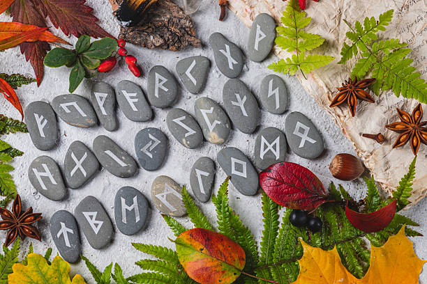 Runes on stones among autumn leaves