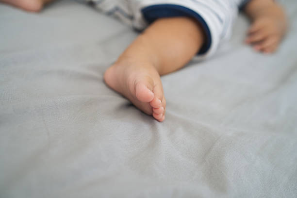 Cute child portrait highlighting small foot indoors.