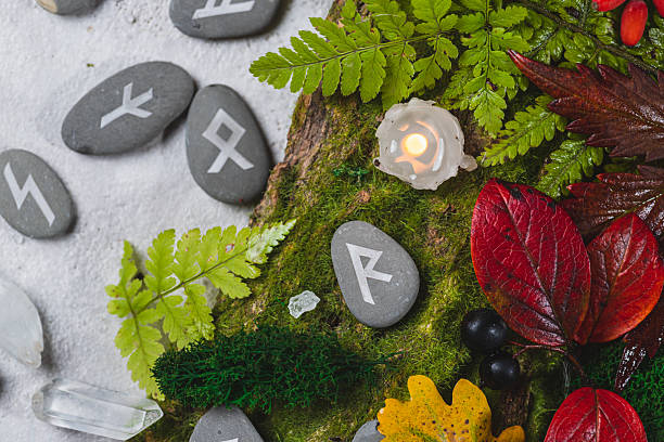 Runes on stones among autumn leaves
