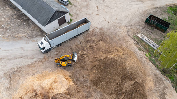 istock Aerial view of a loader loading wood chips to a truck 2236752212