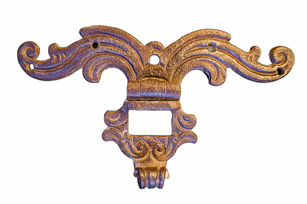 Ornate vintage metal decorative piece with intricate scroll designs displayed against a white background