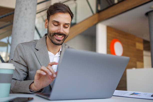 istock Young businessman working on laptop in modern office space 2236753789