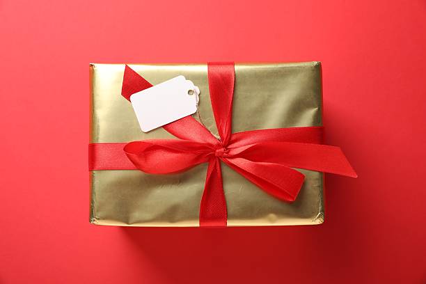 istock Gift box with blank tag on red background, top view 2236755098