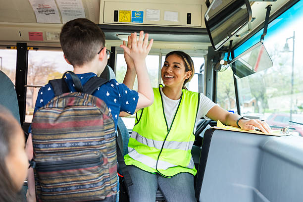 istock Happy School Bus Driver High-Fives Student 2236755890