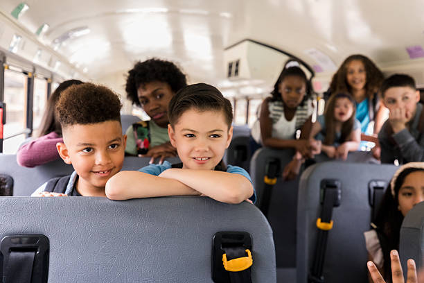 istock Happy Diverse Elementary School Children Riding School Bus 2236755942
