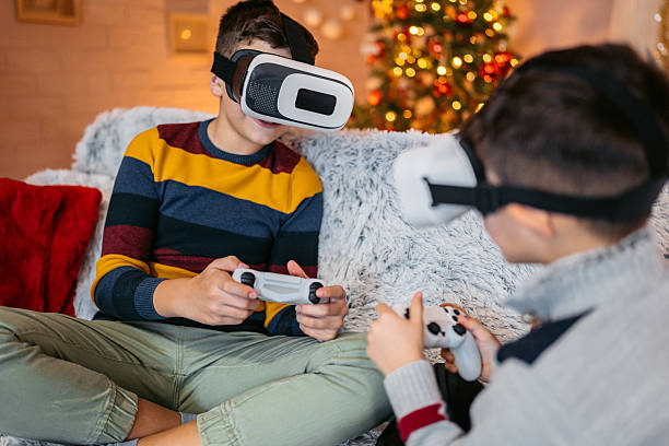 istock Two Boys Playing Video Games On A Joystick While Wearing Virtual Reality Headset At Home During Christmas Holidays 2236756164
