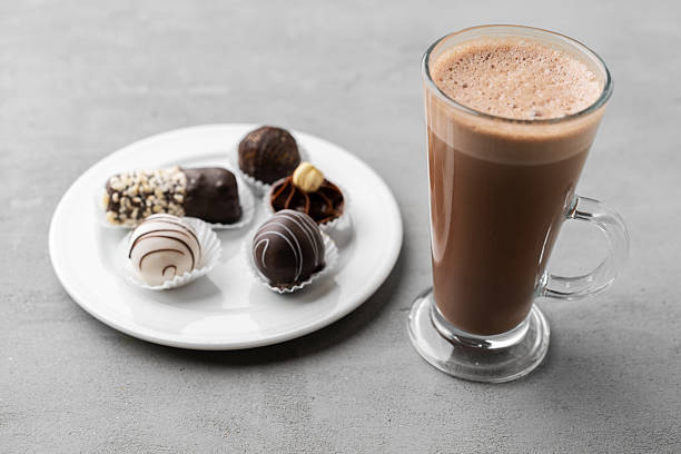 istock Coffee cup and sweet candy on gray table 2236756564