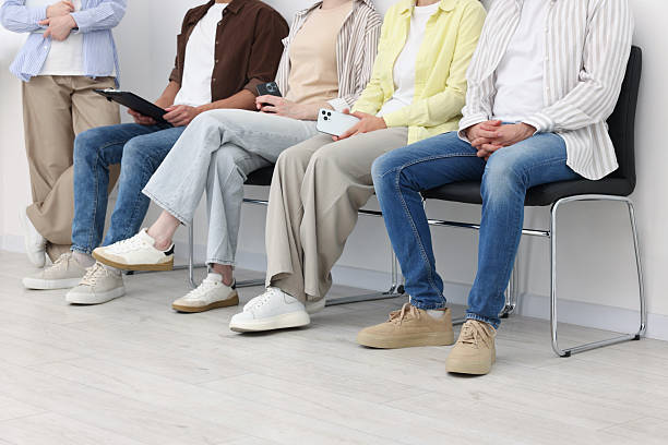 istock People waiting in queue on chairs indoors, closeup 2236757601